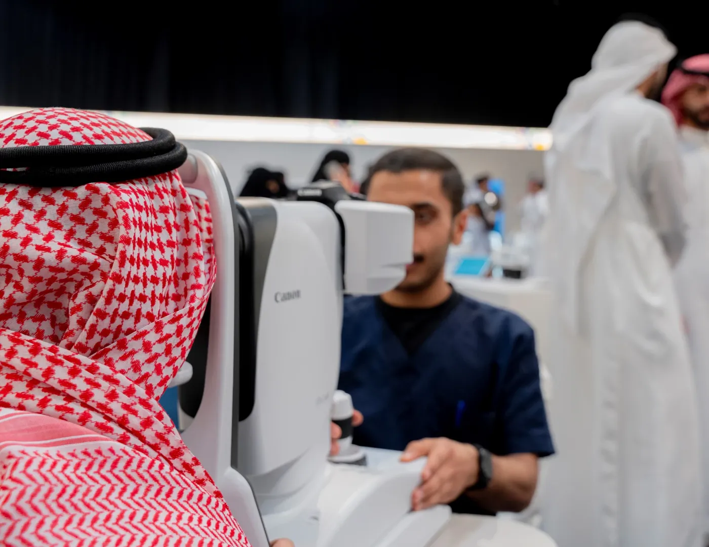 A clinician takes a retinal photo of a patient on a fundus camera.